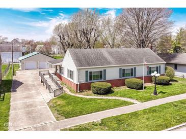 Charming single-story home boasts a well-manicured lawn, brick accents, and a convenient wheelchair ramp at 830 N 16Th St, Elwood, IN 46036