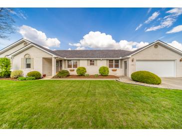 Charming one-story home with a manicured lawn and beautiful landscaping, showcasing curb appeal at 838 Deerfield Rd, Anderson, IN 46012