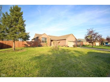 Charming single-story home featuring a well-maintained lawn, brick accents, and a two-car garage at 8911 Country Walk Ct, Indianapolis, IN 46227