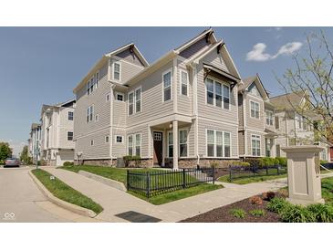 Charming multi-story home with manicured landscaping and sidewalk at 13392 Dorster St, Fishers, IN 46037
