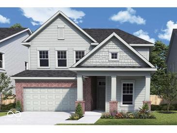 Charming two-story home featuring a brick and siding exterior, attached two car garage, and beautifully landscaped yard at 14223 Coyote Ridge Dr, Noblesville, IN 46060