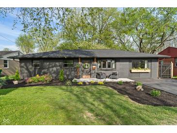 Charming home with a well-manicured lawn, tasteful landscaping, and updated paint at 165 N 9Th St, Zionsville, IN 46077