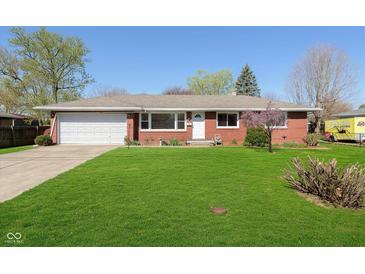 Charming brick home with a well-manicured lawn and an attached two car garage at 166 N Post Rd, Indianapolis, IN 46219