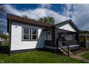 Charming home exterior with a covered porch and updated paint scheme, enhanced curb appeal at 241 S Rural St, Indianapolis, IN 46201