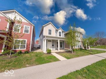 Charming two-story home with a well-manicured lawn and inviting front porch at 326 N Warman Ave, Indianapolis, IN 46222