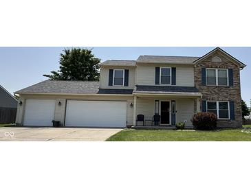 Charming two-story home with an attached two-car garage and well-maintained lawn at 326 Virginia St, Fortville, IN 46040