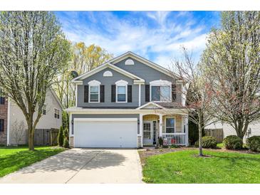 Charming two-story home featuring a well-maintained lawn, attached two-car garage, and inviting front porch at 3466 Firethorn Dr, Whitestown, IN 46075