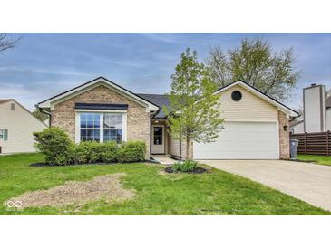 Charming single-story home featuring brick and vinyl siding, attached garage, and well-maintained lawn at 6218 Churchman Way, Indianapolis, IN 46237