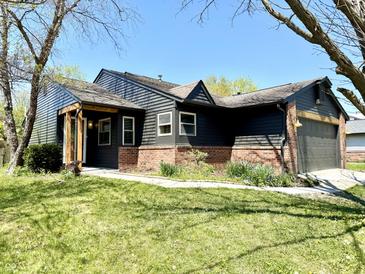 Quaint single-Gathering home featuring neutral siding, brick accents, and a well-manicured lawn at 653 Southridge Ct, Westfield, IN 46074