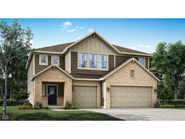 Charming two-story home featuring a brick and siding facade and a spacious three-car garage at 7007 Myra Way, Indianapolis, IN 46239