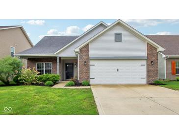 Charming home featuring a two-car garage, brick accents, and a well-manicured lawn at 963 Kempson Ct, Westfield, IN 46074