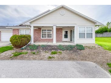 Charming single-story home featuring a brick facade, covered porch, and well-maintained landscaping at 10822 Cape Coral Ln, Indianapolis, IN 46229