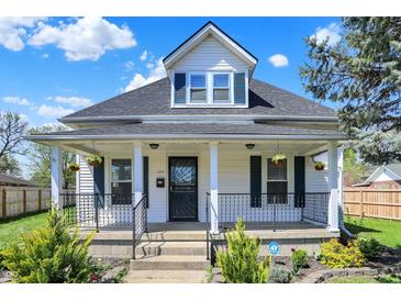 Charming two-story home with white siding, black accents, covered front porch and well maintained landscaping at 222 Raines St, Plainfield, IN 46168