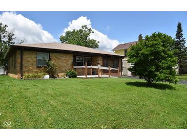 Charming brick home featuring a well-maintained lawn and a quaint front porch at 2726 S Roena St, Indianapolis, IN 46241