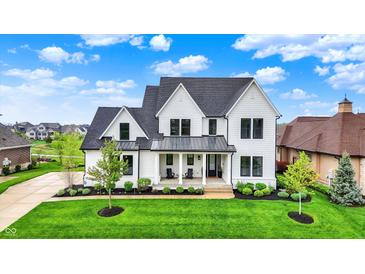 Stunning two-story white home with black trim, lush lawn, and inviting front porch at 284 Chatham Hills Blvd, Westfield, IN 46074