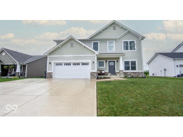 Charming two-story home with a well-manicured lawn, attached two-car garage, and a welcoming front porch at 3235 Myrtle Dr, Lapel, IN 46051