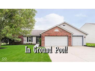 Charming single-story home boasts a brick facade, two-car garage, and well-manicured lawn at 324 Palmyra Dr, Indianapolis, IN 46239