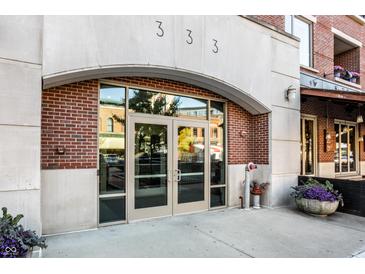 Stylish building entrance featuring double glass doors, brick accents, and modern architectural details at 333 Massachusetts Ave # 204, Indianapolis, IN 46204