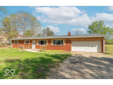 Charming single-story red brick home with an attached garage, a well-kept lawn, and a cozy front porch at 3362 E Sycamore Ln, Mooresville, IN 46158