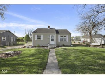 Charming single-story home featuring neutral siding, white trim, and a welcoming front porch at 413 Vasbinder Dr, Anderson, IN 46017