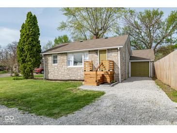 Charming single-story home featuring stone siding, a gravel driveway, and a well-maintained front lawn at 4814 Southeastern Ave, Indianapolis, IN 46203