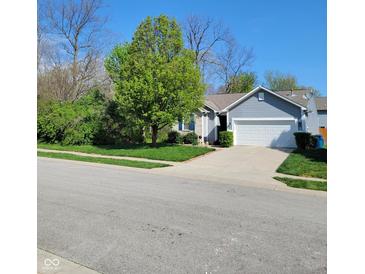 Charming home featuring a well-manicured lawn and a two-car garage at 5912 Accent Dr, Indianapolis, IN 46221