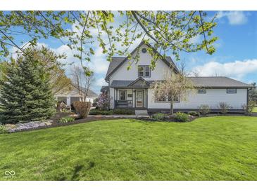 Charming two-story home with a well-manicured lawn and lovely landscaping at 7371 E 100 N, Whitestown, IN 46075