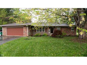 Charming brick ranch home featuring an attached two-car garage and lush green front lawn at 8035 Black Oak Ct, Plainfield, IN 46168