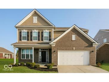 Charming two-story home featuring a two-car garage and nicely landscaped front yard at 10448 Pintail Ln, Indianapolis, IN 46239