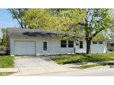 Charming single-story home with attached garage, landscaped yard, and mature trees at 107 N Grant St, Brownsburg, IN 46112
