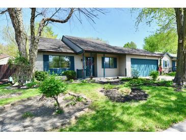 Charming single-story home with a well-maintained front yard, blue shutters, and an attached garage at 1472 Maria Ave, Franklin, IN 46131