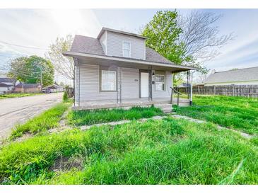 Quaint two-story home featuring a cozy front porch and fresh exterior paint at 274 Leeds Ave, Indianapolis, IN 46201
