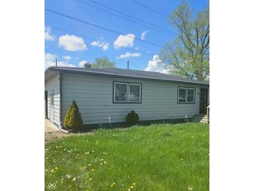 Side view of home, gray siding, dark trim, lawn with weeds, blue sky with scattered clouds at 4006 Kenneth Ave, Indianapolis, IN 46226