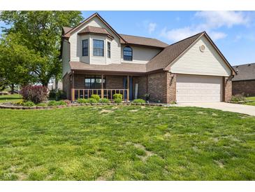 Charming two-story home featuring a covered porch, brick accents, and a well-manicured front yard at 500 Meadowlark Ct, Whiteland, IN 46184