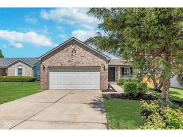 Charming brick home with a well-maintained lawn and two-car garage, perfect for Gathering living at 5622 Imperial Woods Cir, Indianapolis, IN 46224