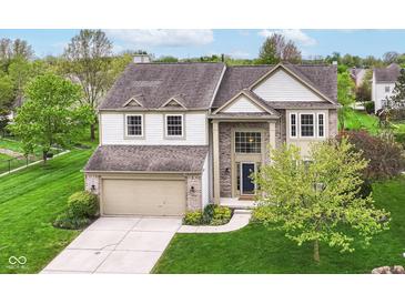 Charming two-story home with a well-manicured lawn and attached two car garage at 6164 Parrington Dr, Indianapolis, IN 46236