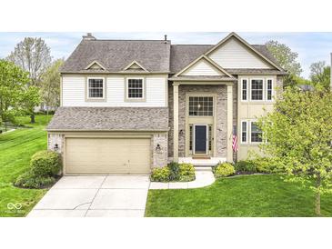 Beautiful two-story home featuring brick and siding exterior, an attached two-car garage, and manicured landscaping at 6164 Parrington Dr, Indianapolis, IN 46236