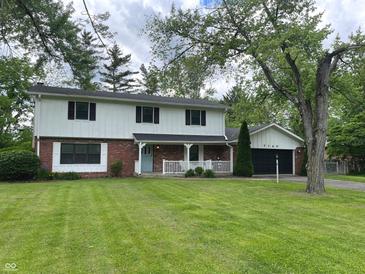 Charming two-story home with a well-manicured lawn and attached two car garage at 7140 Avalon Trail Dr, Indianapolis, IN 46250