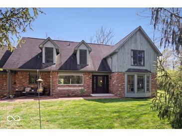 Charming two-story home with a brick facade, dormer windows, and a well-manicured lawn at 7425 E 300 S, Whitestown, IN 46075