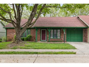 Charming single-story brick home with a well-maintained lawn, red roof, and green trim at 11 Woodacre Dr, Carmel, IN 46032