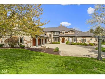 Stunning custom home with circular drive and attached 3 car garage, professionally landscaped at 12010 Landover Ln, Fishers, IN 46037