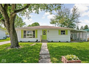 Charming single-story home with neat landscaping, vibrant shutters, and a welcoming walkway at 1212 N 10Th St, Elwood, IN 46036