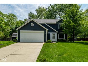 Charming two-story home featuring navy siding, white trim, an attached two-car garage, and a well-manicured lawn at 12577 Pointer Pl, Fishers, IN 46038