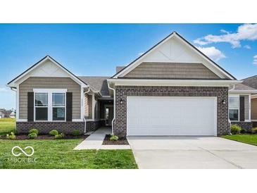 Charming, single-story home with a brick facade, attached garage, and well-manicured lawn in a suburban neighborhood at 2257 Aviary Ln, Danville, IN 46122