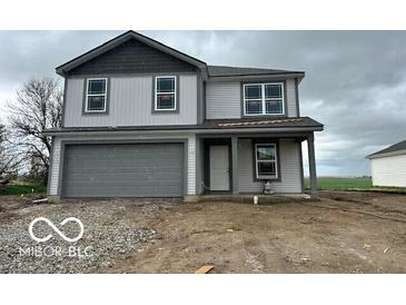 Charming two-story home with a gray garage door and gray accents under a cloudy sky at 3312 W Longbranch Dr, Monrovia, IN 46157