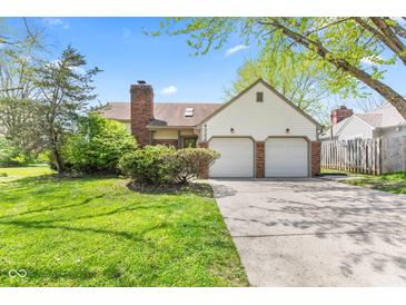 Charming home with a two-car garage and well-maintained front yard and brick chimney at 4322 Matrea More Ct, Indianapolis, IN 46254