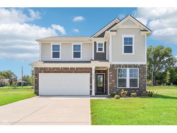 Inviting two-story home featuring a brick and siding facade, well-manicured lawn, and an attached two-car garage at 4718 E Shadowbrook Dr, Camby, IN 46113