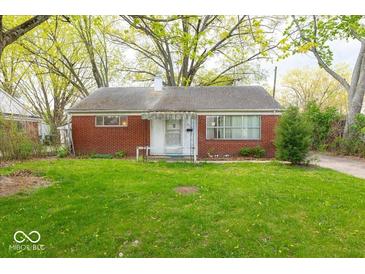 Charming brick home with a well-manicured lawn and mature trees in a peaceful neighborhood at 476 Southgate Dr, Greenwood, IN 46143