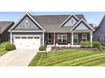Charming single-Gathering home featuring a manicured lawn and inviting front porch, plus a two-car garage at 5158 Montview Way, Noblesville, IN 46062