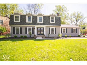 Charming two-story home featuring a well-manicured lawn and inviting front entrance at 5829 Lasalle St, Indianapolis, IN 46220
